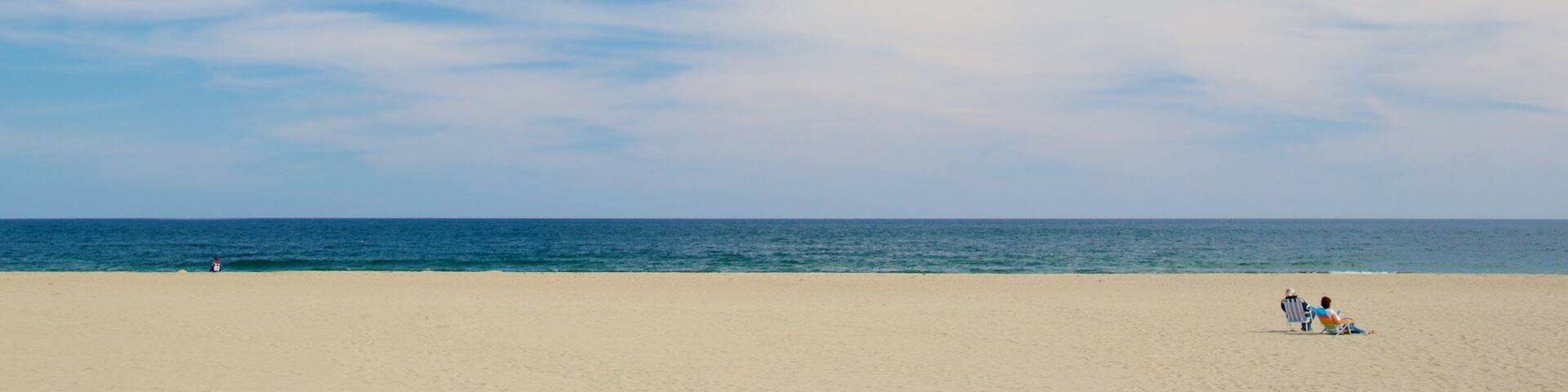 Hampton Beach featuring a sandy beach as well as a couple