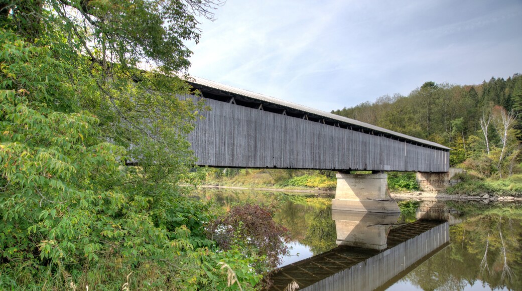 covered bridge over water with reflection Lancaster New Hampshire