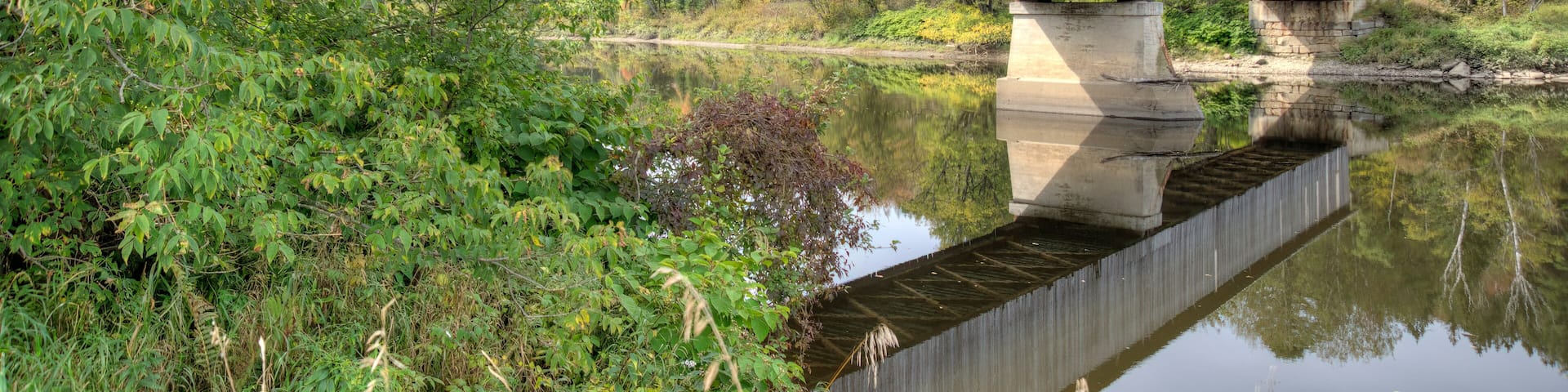 covered bridge over water with reflection Lancaster New Hampshire