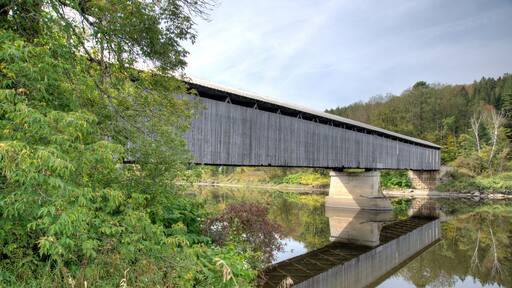 covered bridge over water with reflection Lancaster New Hampshire