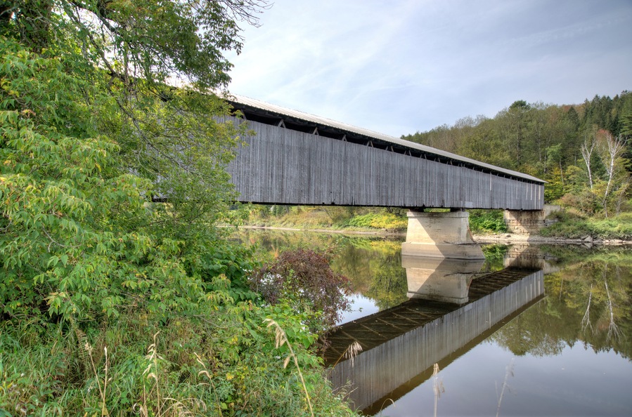 covered bridge over water with reflection Lancaster New Hampshire