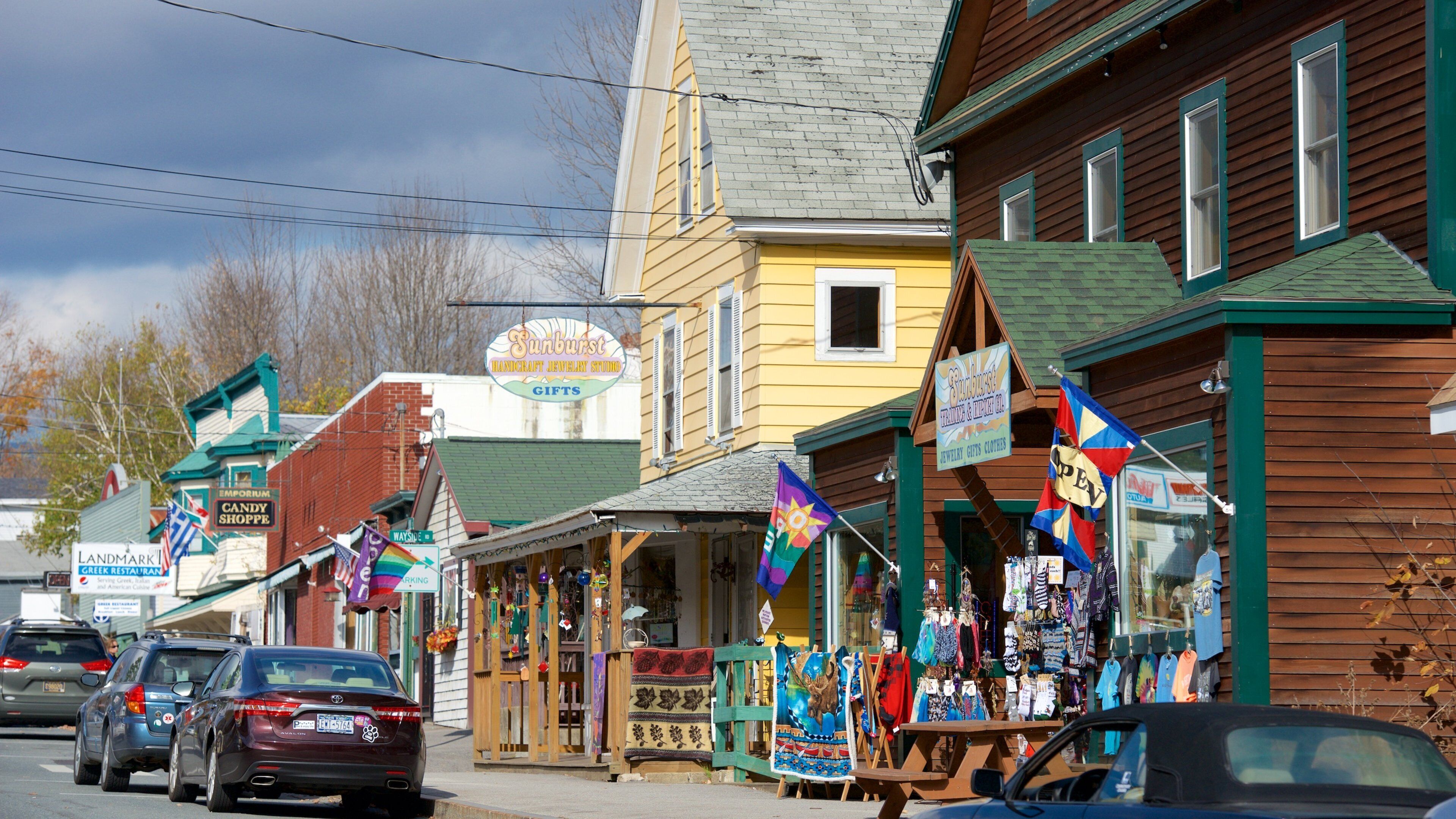 A street with shops, including a jewelry store and a candy shop.