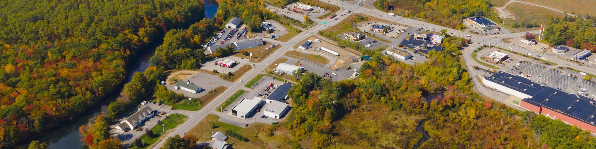 Interstate Highway 93 at Exit 20 with US Route 3 in White Mountain National Forest aerial view with fall foliage, Town of Tilton, New Hampshire NH, USA.