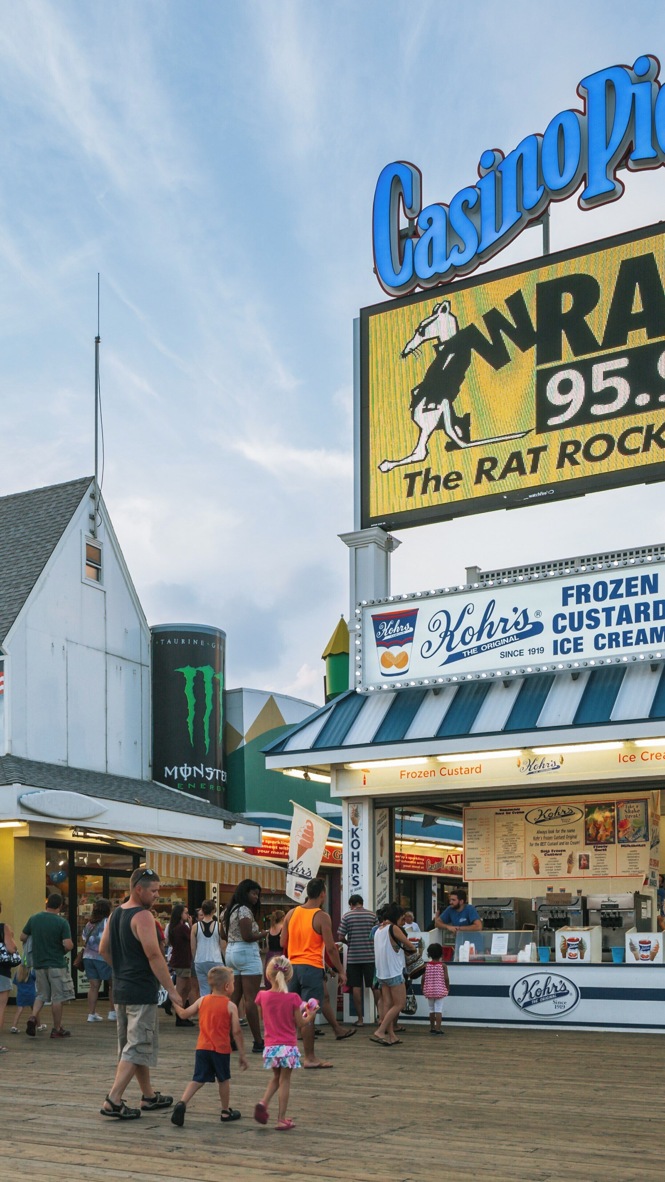 Colorful summer evening at Casino Pier in Seaside Heights, New Jersey with families enjoying treats and entertainment