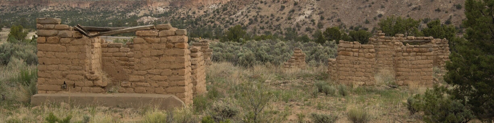 The Duchess Castle. Several miles North of Santa Fe but only about 5 miles from White Rock. No signs showing you where to start your hike though. A couple ladies lived there, way back, and taught the local Indians pottery techniques. Can't imagine living there back in the 30's because there would have been nothing close. 
This is part of the Bandelier National Monument.