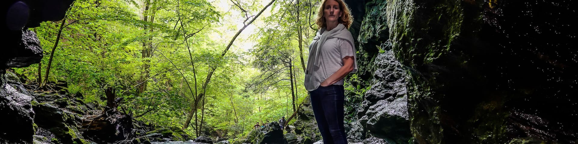 Dover Stone Church, New York, USA A woman standing in a stream of water.