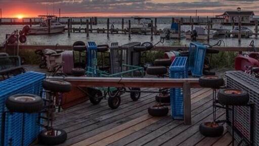 The sun set over the dock in fair harbor