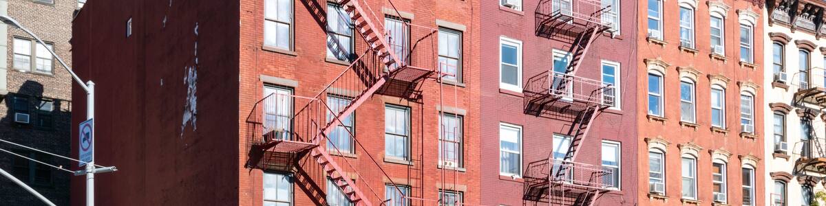Busy street scene with crowds of people walking through the intersection on 7th Avenue and Bleecker in the Greenwich Village neighborhood of New York City