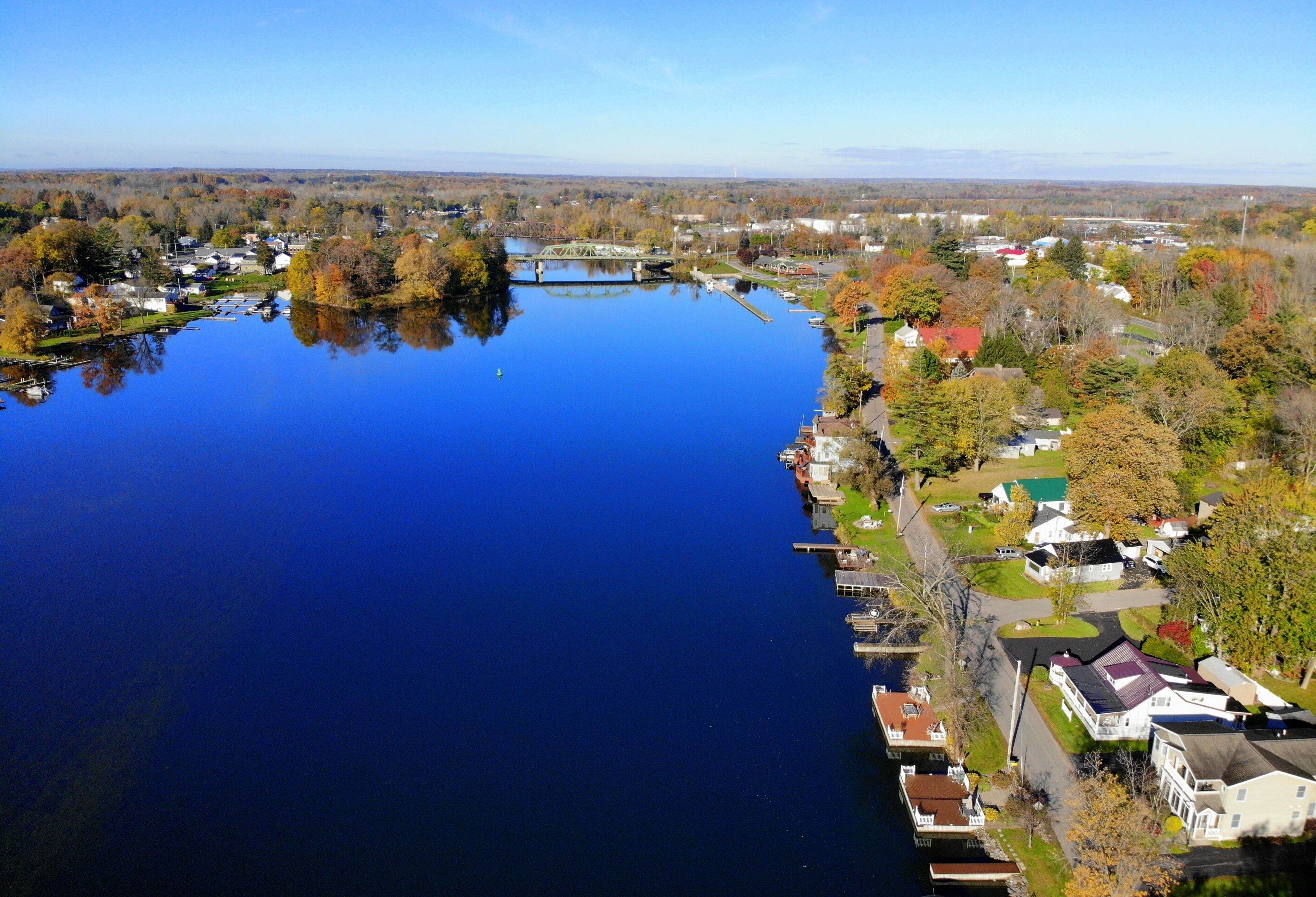 The aerial view of the waterfront homes by Oneida Lake with stunning fall foliage near Syracuse, New York, U.S.A
