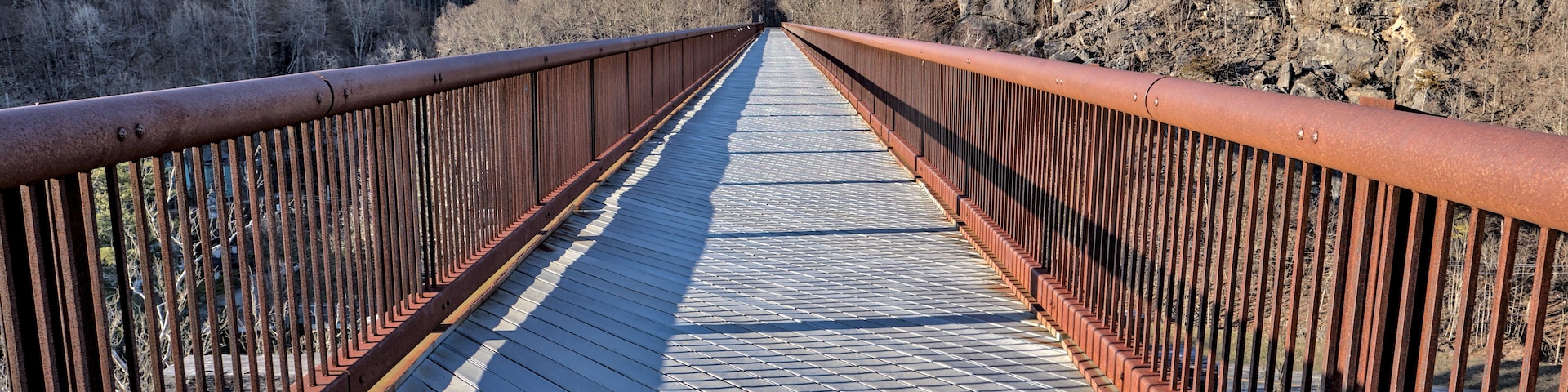 rosendale railroad trestle bridge surface bike lane with joppenbergh mountain and catskill moutains in the background (wallkill valley rail trail pedestrian, cycling path) rusty metal rail