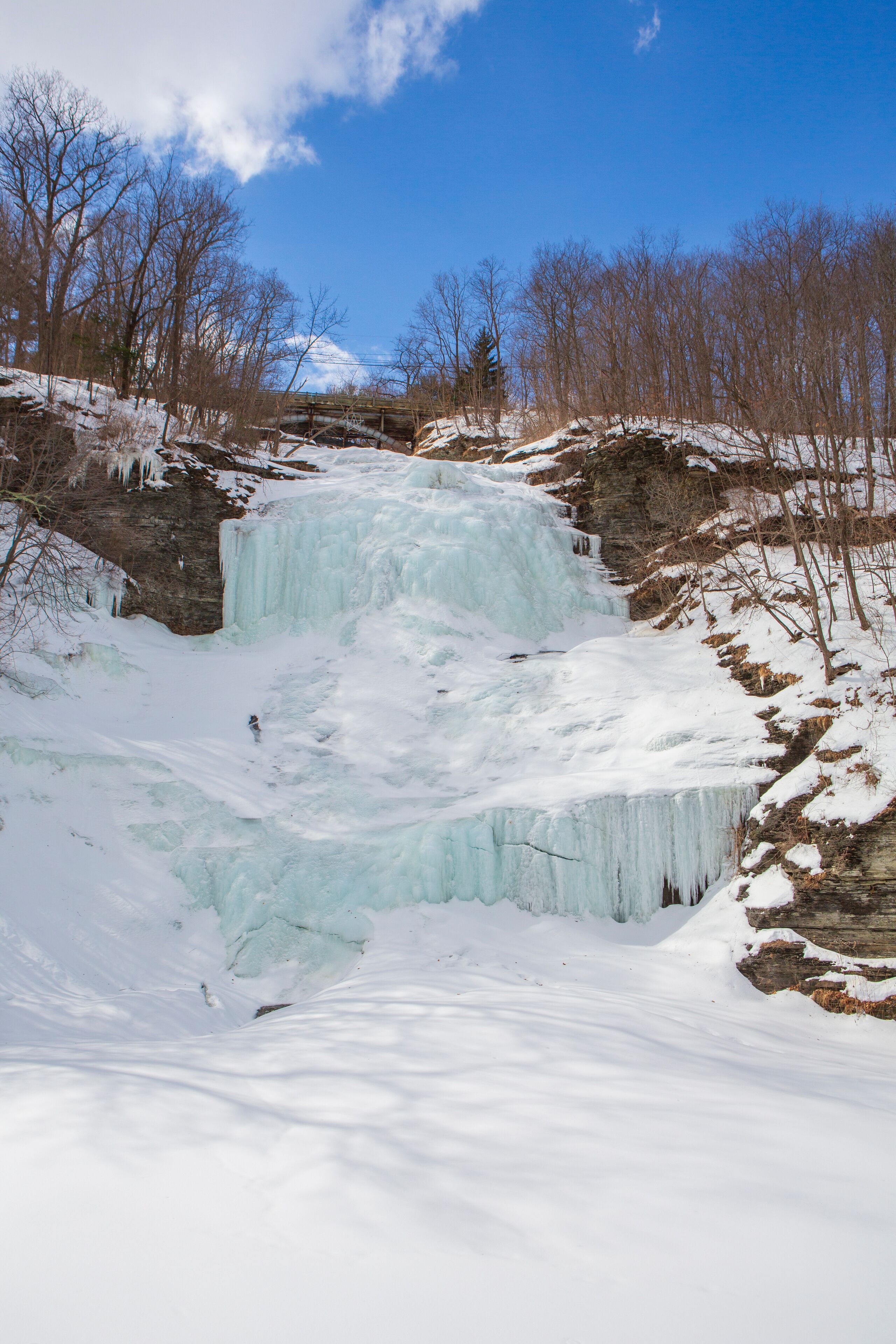 A vertical image of Montour Falls, frozen on a sunny winter day, which is located in Schuyler County, New York State about 10 miles south of Watkins Glen.