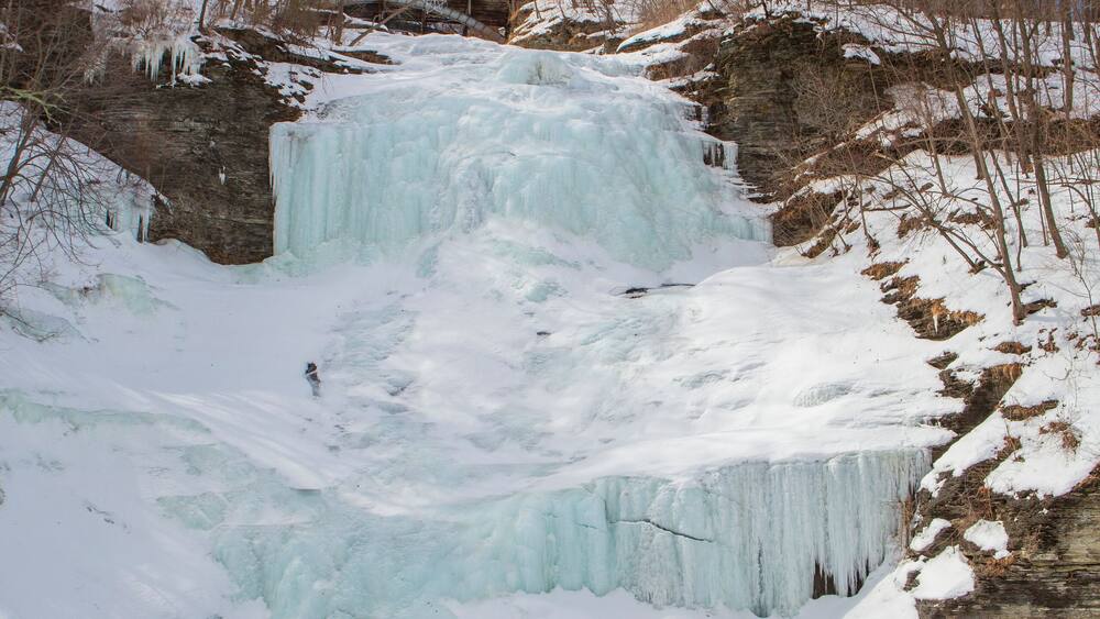 A vertical image of Montour Falls, frozen on a sunny winter day, which is located in Schuyler County, New York State about 10 miles south of Watkins Glen.