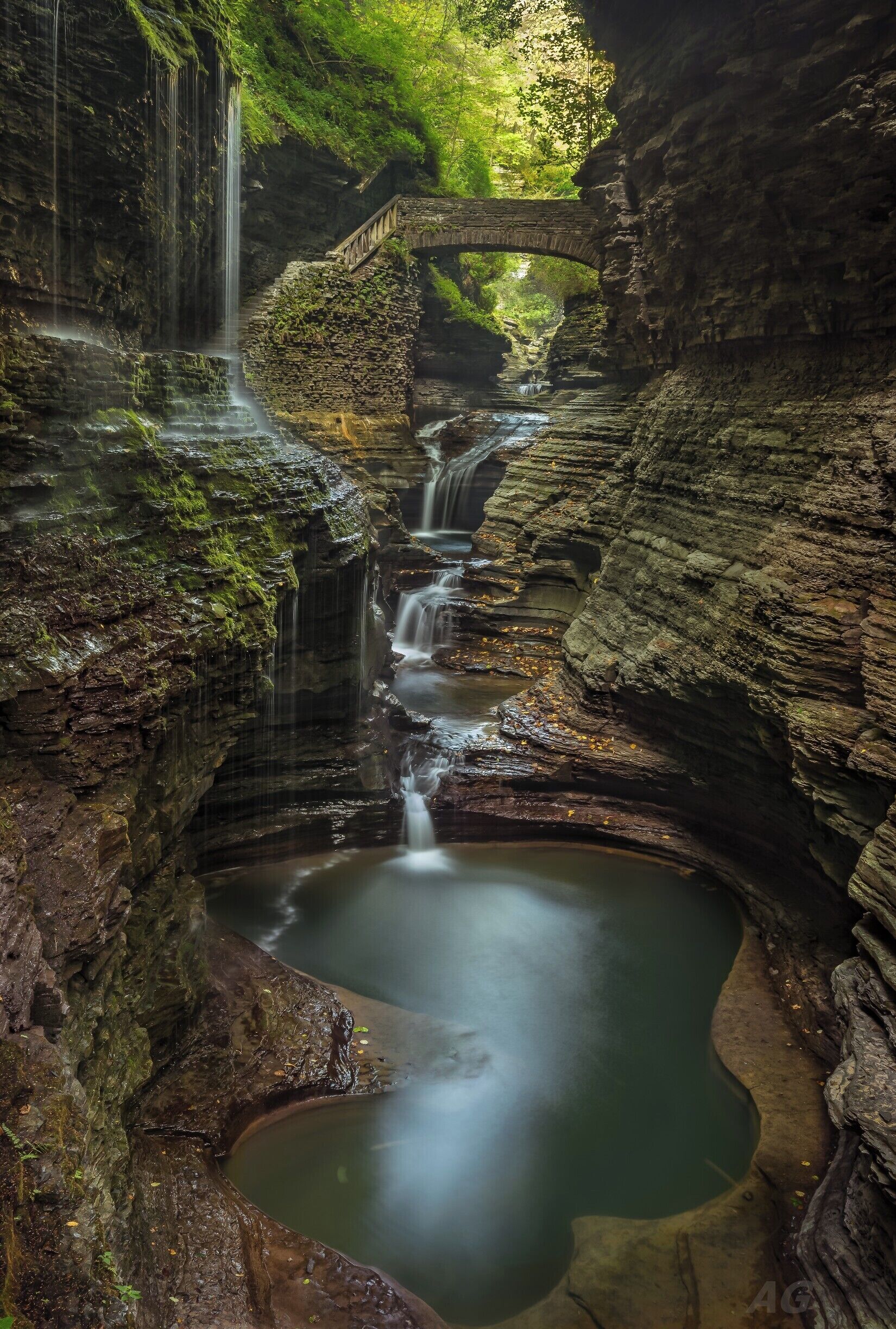 This is an image from back in September when I was in upstate New York visiting family. This image is of Rainbow Falls in the Watkins Glen State Park near Ithaca. It is a very popular location - tourists throng here in their hundreds to walk the various trails. As such, best advised to visit very early in the mornings. Preferably start while it's still dark.

The gorge that runs along the park is extremely beautiful. At one point in time, this area was all under water and the gorge has been formed as a result of erosion of the softer layers of soil and rock. Even today, the gorge is ever changing due to the action of water.
There's loads of compositions possible all along the trail but Rainbow Falls is perhaps the most well known and most photographed location in the gorge. This location truly is stunning - you have to see it with your own eyes to take in the beauty of the place. The cascading waterfall, the stone bridges, the varying colors of the water due to the reflections from the canyon walls - it all adds up to make this a truly remarkable place.

Watkins Glen also used to have a street circuit for Formula 1 races. The roads are lined with flags to mark the course. In addition there's the marina and many good eating joints around town. Ithaca and Cornell are close by too. 

Owing to where I was staying, I had to start driving at 3 AM to make it to this place before the crowds descended. At the end of it, it was well worth it.

Thank you for stopping by.

#waterfall #NY #USA #WatkinsGlen #RainbowFalls #Gorge #Canyon
#waterfalls #roadtrips #colorful #hiking #weekend #waterlust #roadtrip #blue #bestof5 #green #springfun #banksyNY