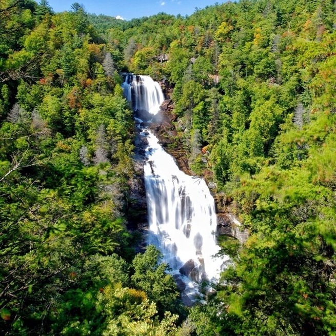 The upper Whitewater Falls is the highest waterfall east of the Rockies, falling 411 feet! It's about 60 miles from downtown Asheville and part of the Whitewater River in the Jocassee Gorge area of North Carolina just before you reach South Carolina. For an excellent view of Whitewater Falls, The walkway begins at the end of the parking lot and is accessible to wheelchairs. A lower overlook with an even better view is located at the bottom of 154 wooden steps. These waterfalls are quite a hike, so be prepared for a little hike. These falls are without a doubt one of the prettiest falls I've ever seen. If your very adventurous there is a trail down into to the river below. It is worth the trip, I would go in summer to fall.
