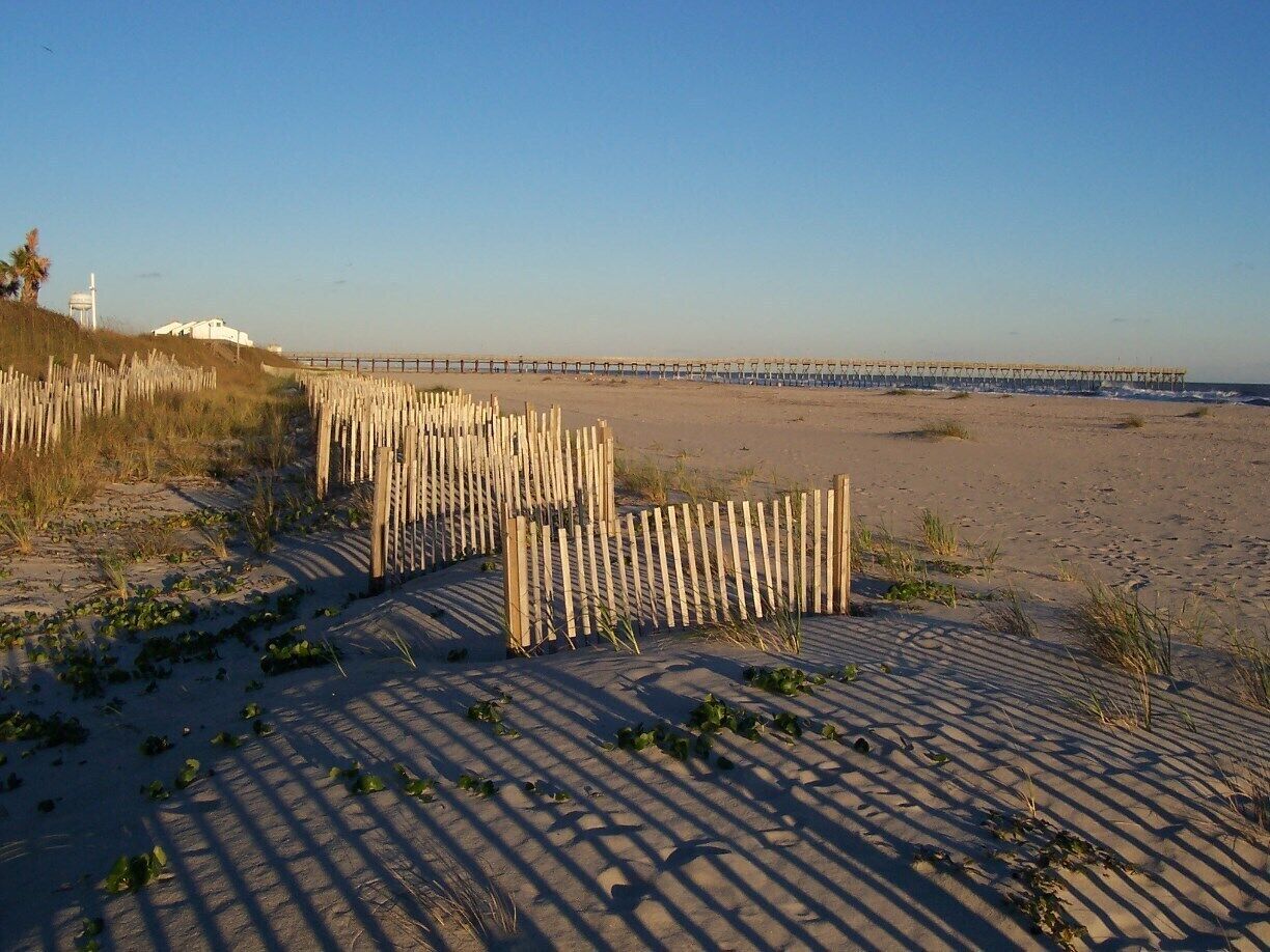 Looking toward the fishing pier at Sunset Beach, a family beach with next to no commercial interests. No hotels, just homes.