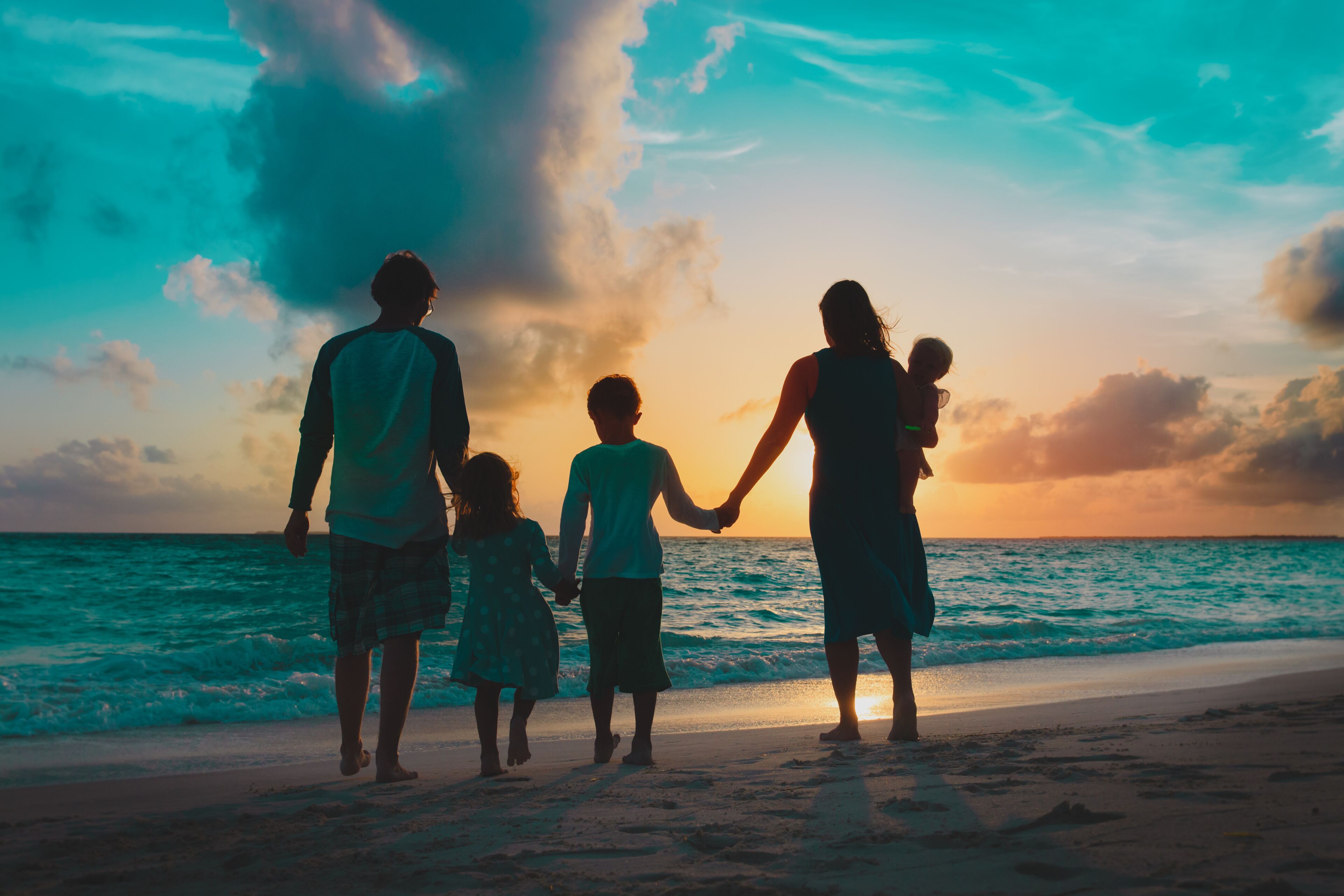 happy family with kids walk at sunset beach