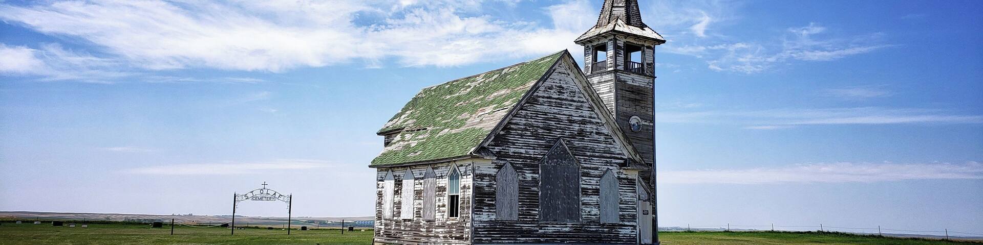 St. Olaf Lutheran Church–Abandoned North Dakota.
St. Olaf Lutheran Church sits abandoned on a gravel road in Williams County in North Dakota. In a 360 degree view, the only man-made structures visible are the recently dug oil rigs.
With never more than 60 people in the congregation, this church eventually merged with a congregation in the nearby town of Tioga. Considering this church has been unused for at least 40 years, but probably longer, it wasn’t in that bad of shape.
Places like these are so much a part of the landscape in this region of the MidWest.
#USA #Travel #Trovember