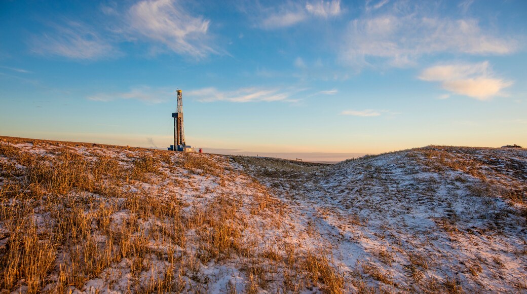 Mid distance view of drilling rig on snow covered field