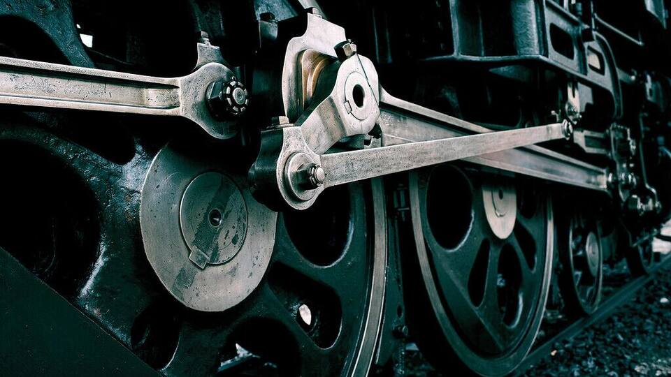 A close-up of a train's mechanical components, including wheels and axles.