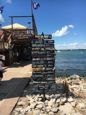 A signpost with distances to various cities and landmarks.