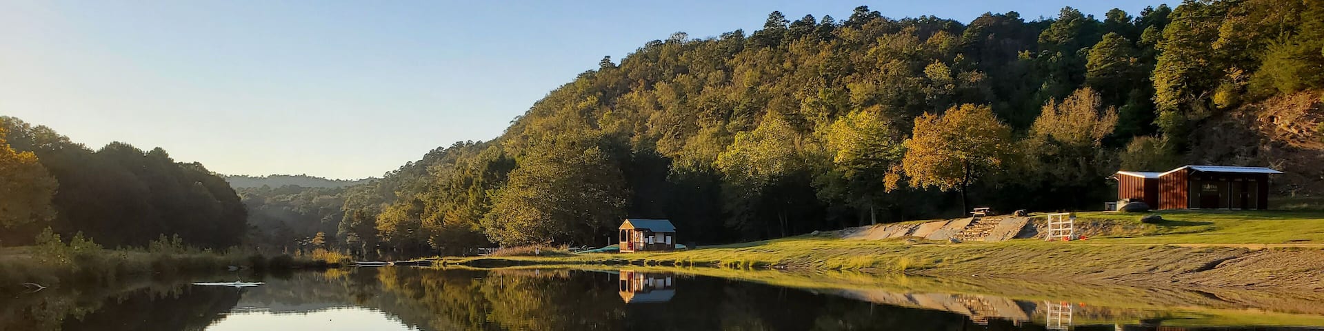Scenic view of forest tree's reflection on Broken Bow lake water in Hochatown. Oklahoma