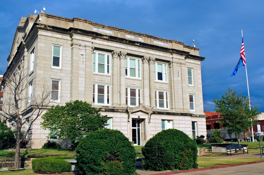 Side view Creek County Courthouse stormy morning historic downtown Sapulpa, Oklahoma. Route 66 Greco/Greek Revival style of architecture. Small town USA.