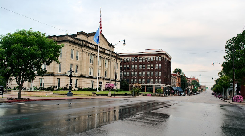 Looking west on Route 66 rainy morning Sapulpa, Oklahoma. Wet pavement of Dewey Avenue reflects the Creek County Courthouse. Small town USA.