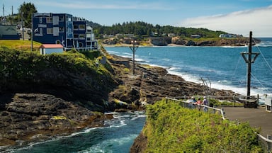 A coastal area with a Channel House lodging, rocky cliffs, and a view of the ocean.
