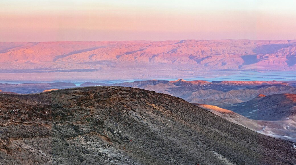 colorful panorama of the sun setting on the moav mountains in jordan and the dead sea from the negev desert hills near Arad in Israel