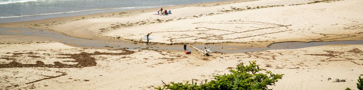 Oceanside which includes a sandy beach, island views and general coastal views