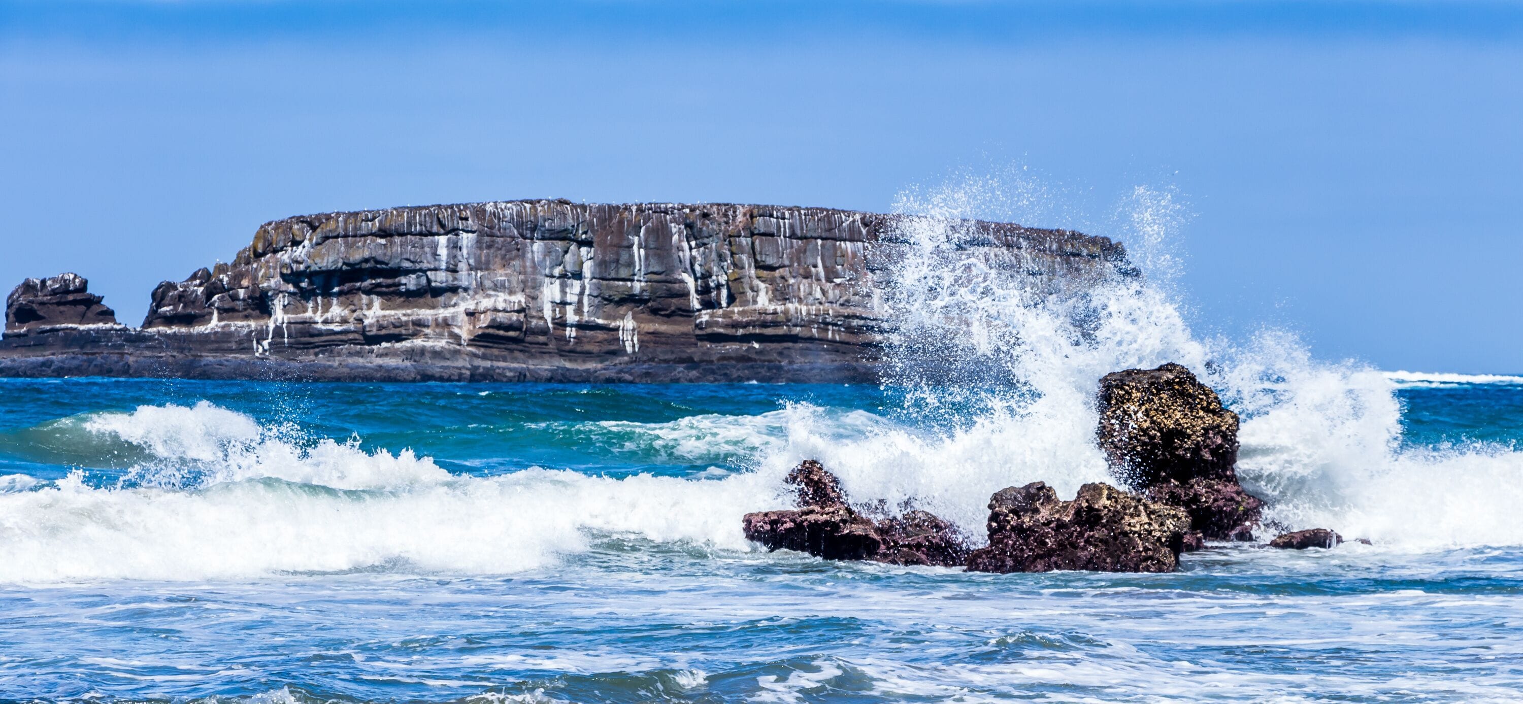 Ocean waves crash against rocks Otter Rock Oregon