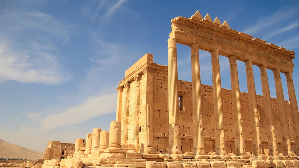 Ancient ruins with columns and stone blocks.