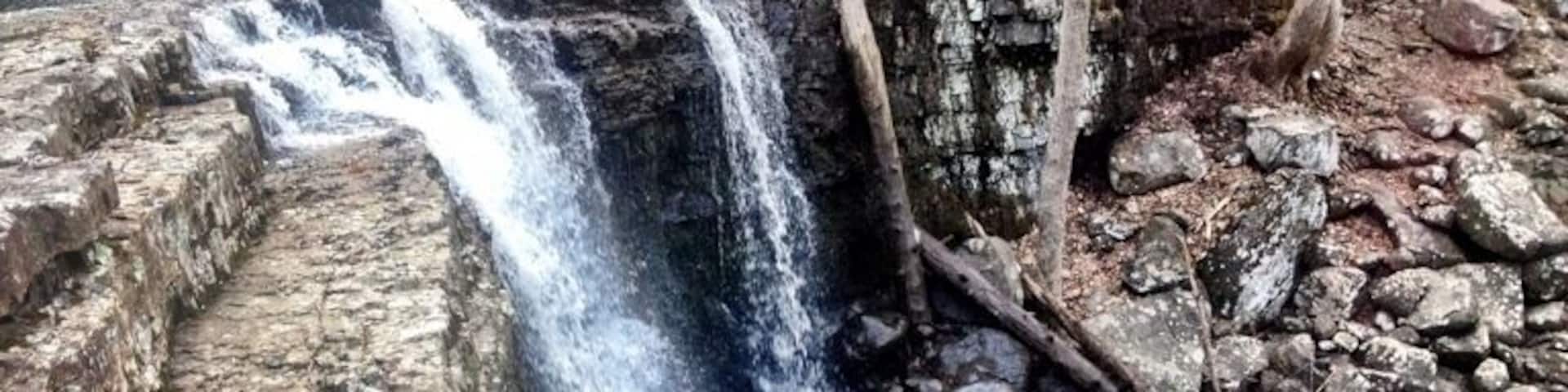 Ringing rocks county park is mostly known for its field of boulders, that, when struck with a hammer, ring out in a variety of tones not normally associated with rocks. For first time visitors, it's amazing, and for musically inclined people, it may hold the entirety of their interest.
However, if one is to hike beyond the boulder field (fun in and of itself, rock hopping) there is a creekbed that is hewn into the side of the hill, cascading across a variety of stone waterfalls. Hiking north along these beautiful steps brings you to this, the largest waterfall in Bucks County.
The park is, without a doubt, one of my favorite places in the county, and perhaps the state. A great place to spend an afternoon.