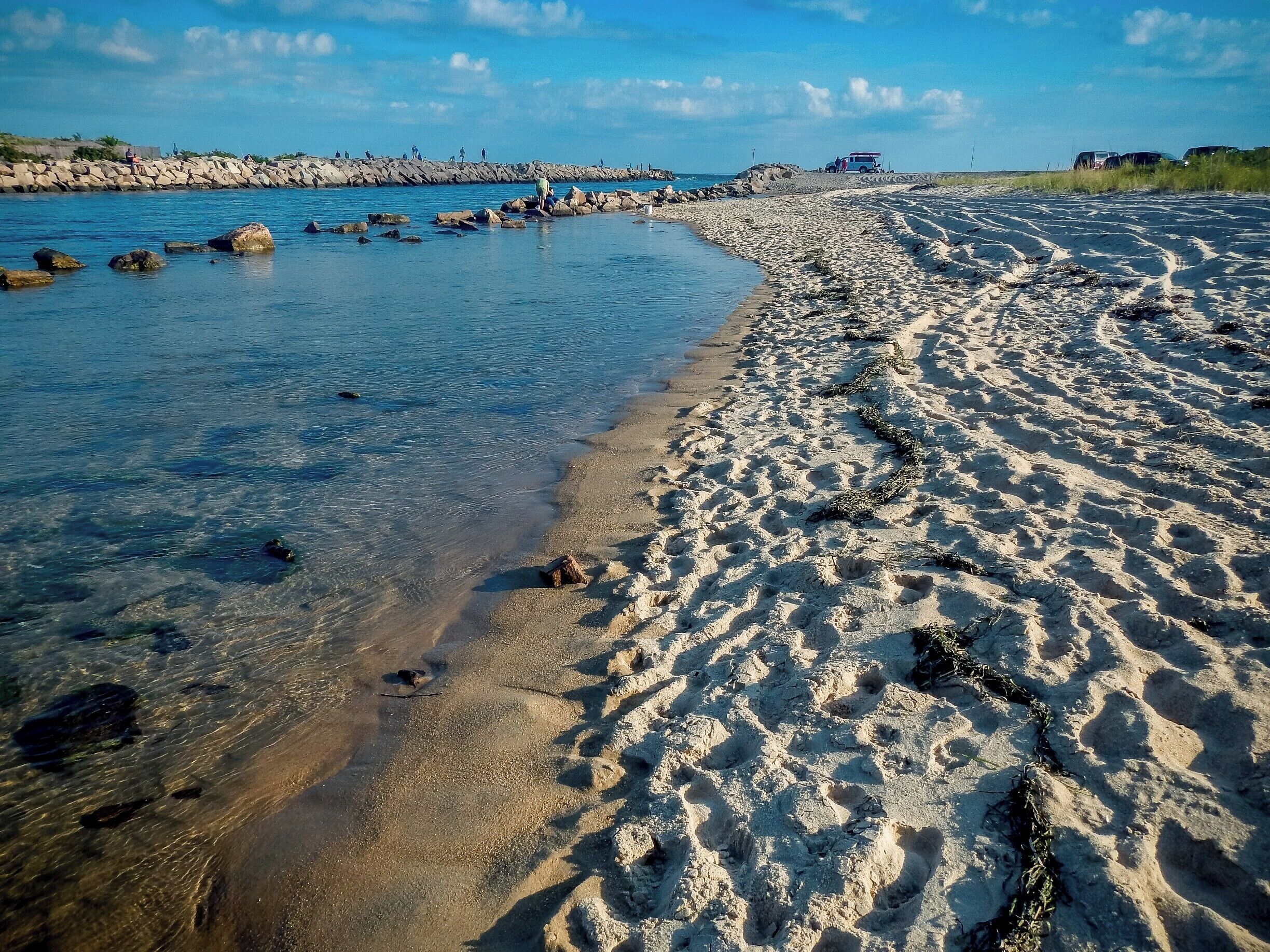 The Charlestown Breachway. This narrow inlet connects Ninigret Pond with the Atlantic Ocean. During the peak tides, the current can be quite strong. Strong enough to make it difficult, if not impossible, to swim across the short distance.  On the right side of the image is East Beach, a magnificent miles long beach. The only way to access it is either by foot, four wheel vehicle ( no paved roads, only sand - and permit is required ) or by boat.  

#beach
