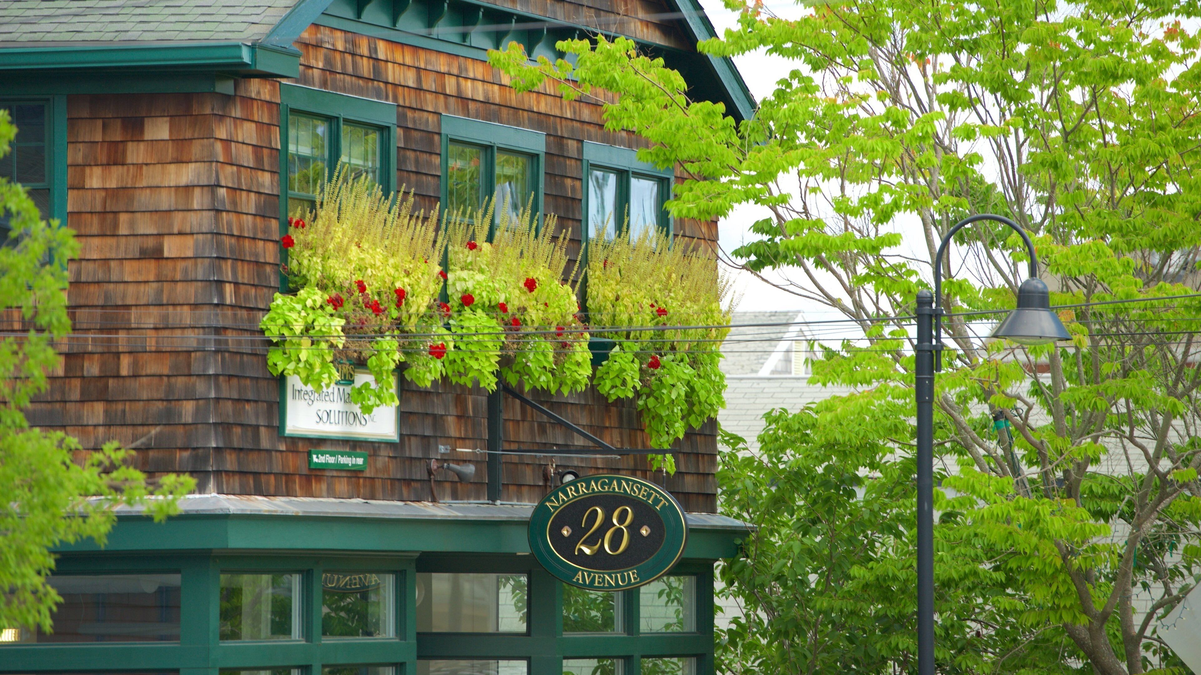 A wooden building with a sign reading "Narragansett 28 Avenue".
