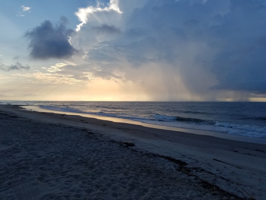 Rain over the ocean at sunrise. Edisto beach is quiet and beautiful. The perfect place to just enjoy the surf.