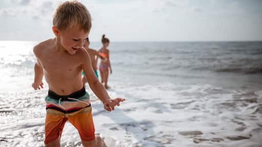 Kids playing in waves on shoreline in South Carolina