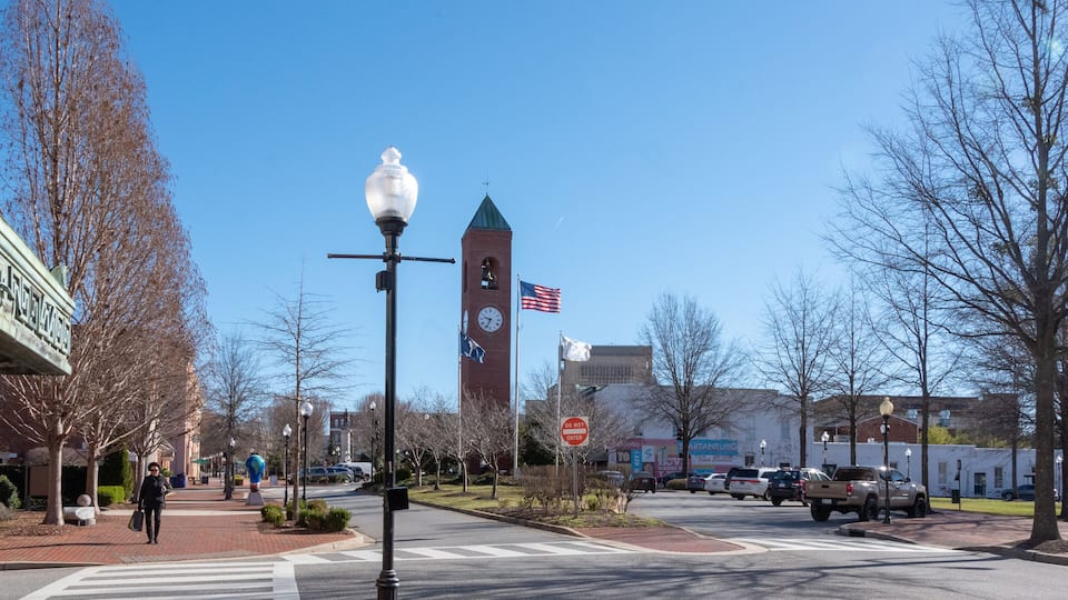 A street with a clock tower, a 'Do Not Enter' sign, and a 'Love' store.
