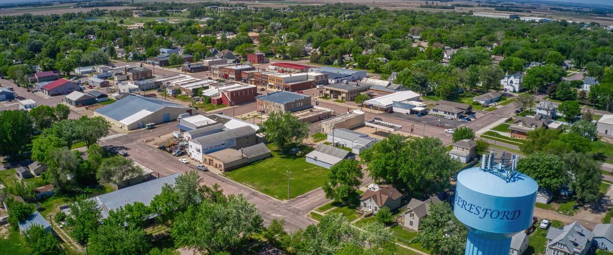 An aerial view of a town with a prominent blue water tower labeled 'VERESFORD' and various buildings, roads, and greenery.