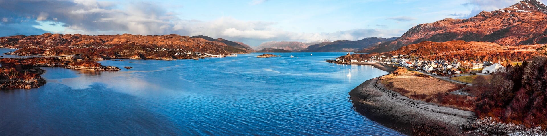 Aerial panoramic view of blue water with mountains on the shore in Kyle of Lochalsh, Scotland, UK