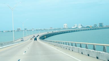 Panorama view Queen Isabella Memorial Bridge Causeway over Gulf Coast and South Padre Island buildings background, concrete pier-and-beam bridge, steel cantilever main beam span from Port Isabel