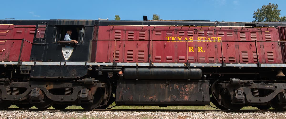A Texas State Railroad train with a caboose and two locomotives.