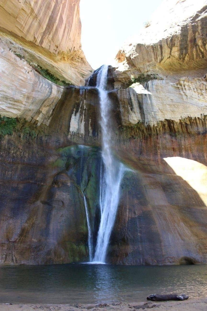 A waterfall cascading down a rock face into a pool.