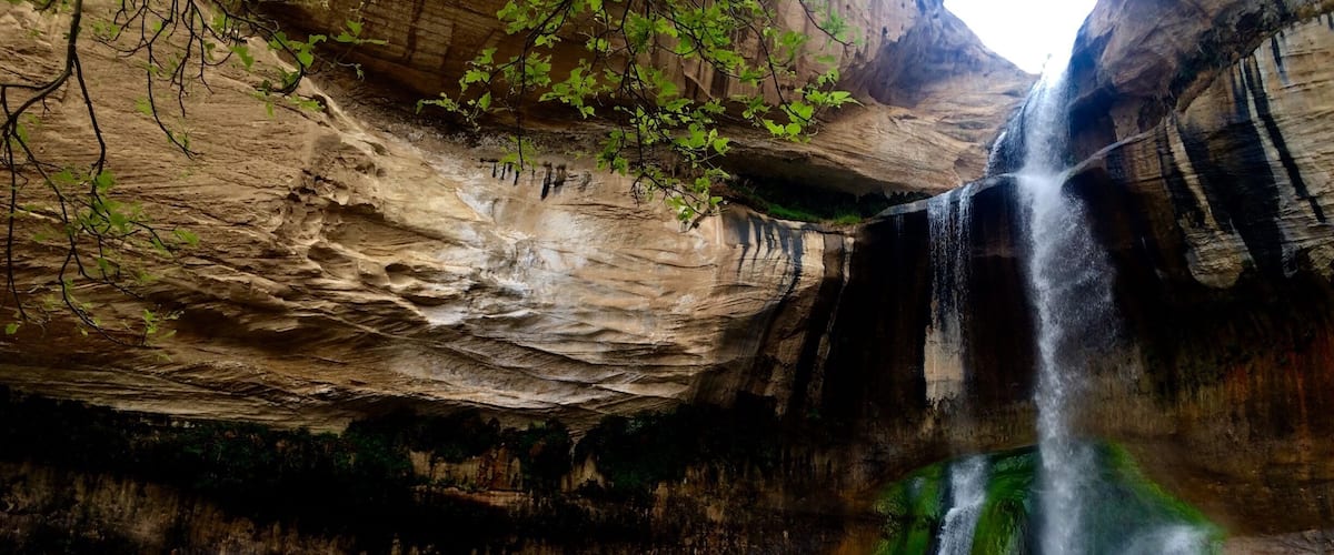 Hiking bud taking a photo of the waterfall in Boulder, Utah