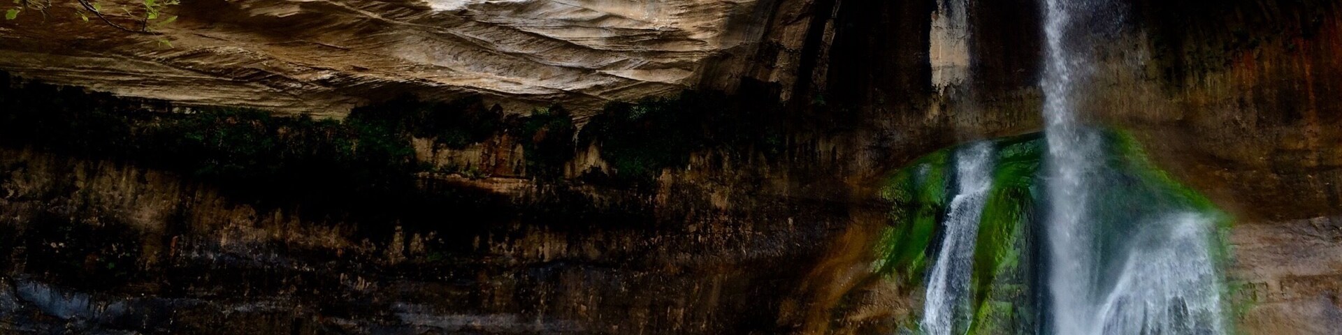 Hiking bud taking a photo of the waterfall in Boulder, Utah