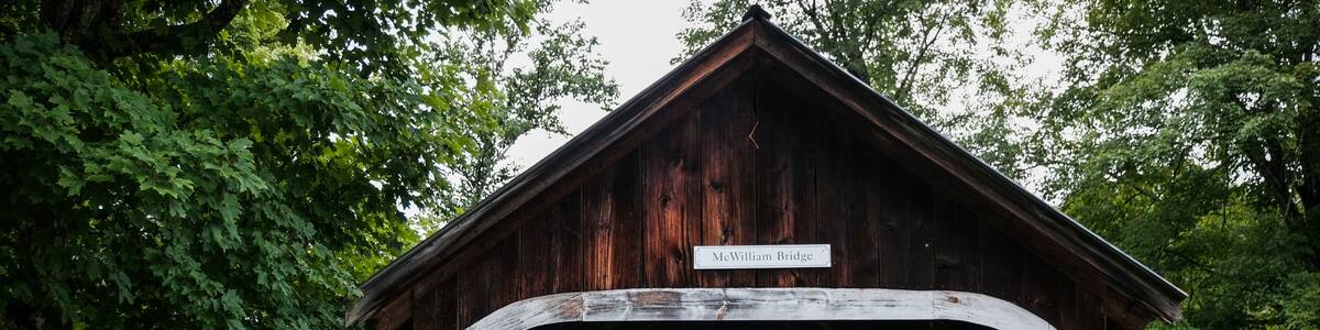 Un pont en bois couvert, appelé pont McWilliam, sur lequel est affiché un panneau indiquant : « Circulation des véhicules interdite, passage piéton uniquement ».