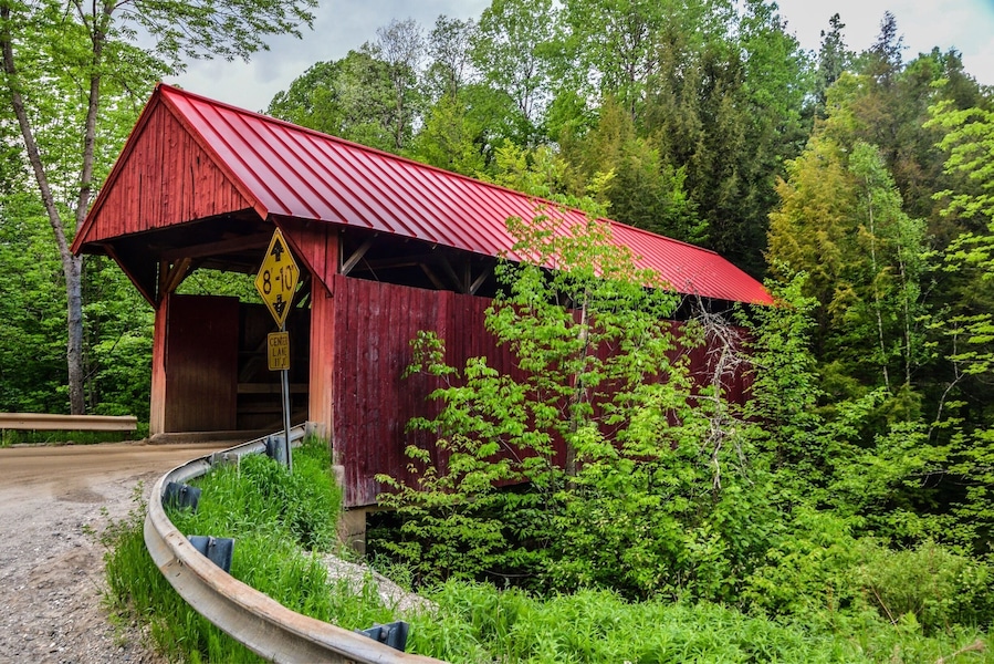 Beautiful old red painted covered bridge in Morrisville, VT