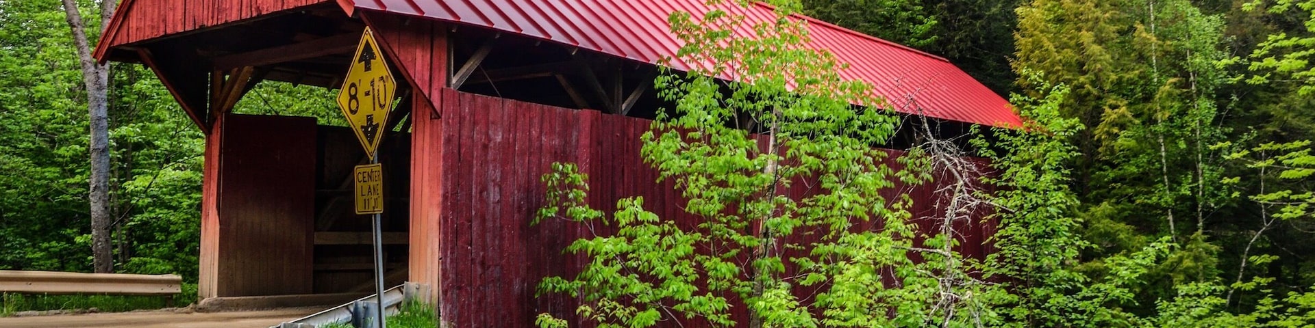 Beautiful old red painted covered bridge in Morrisville, VT