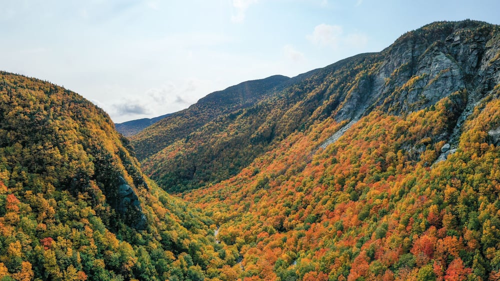 A mountainous landscape with autumn foliage.