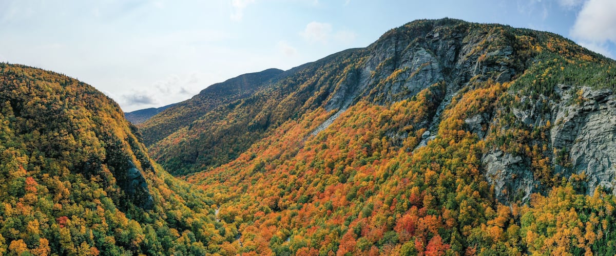 A mountainous landscape with autumn foliage.